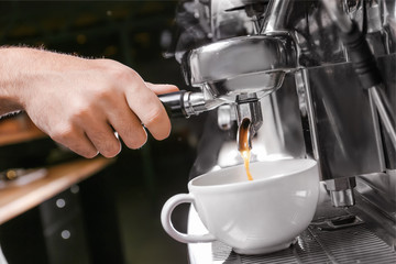 Fototapeta na wymiar Barista preparing fresh aromatic coffee in cafe, closeup