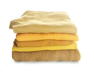 Stack of modern clothes on white background