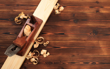 chisels plane and sawdust on a wooden table.