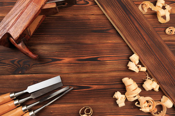 chisels plane and sawdust on a wooden table.