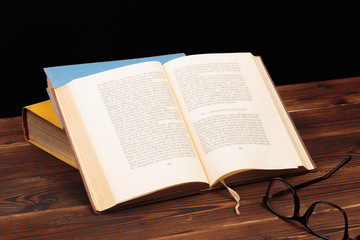 Fototapeta premium Vintage book, open, on old wooden table.