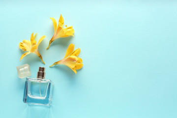 Beautiful composition with flowers and perfume on color background