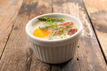 baked egg with cream, asparagus and tomato