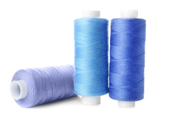 Bright sewing threads on white background