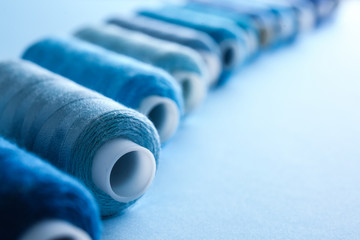 Many sewing threads on color background