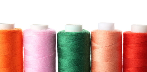 Colorful sewing threads on white background