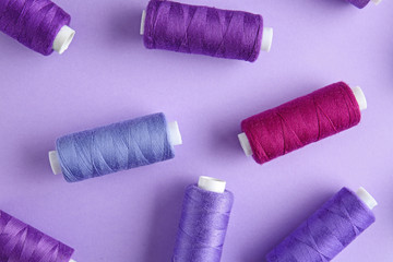 Many sewing threads on color background