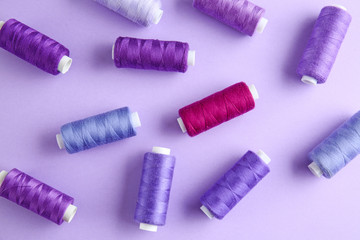 Many sewing threads on color background