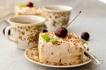 Tiramisu, a traditional Italian dessert in a light background. Close-up
