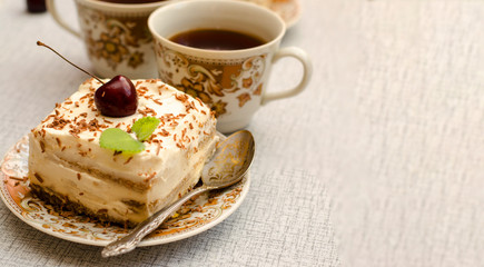 Tiramisu, a traditional Italian dessert in a light background. Close-up
