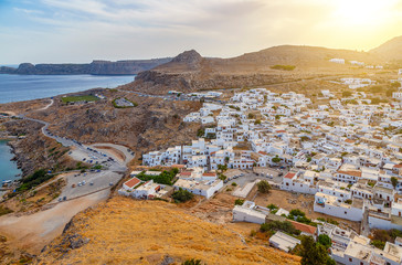 Rhodes Island in Greece. City on hill with white residential buildings and touristic hotels.