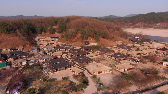 Fly in towards traditional Korean village