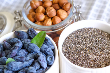 Hazelnut and honeysuckle in bowls close-up. View from above. The concept of a healthy food and diet.