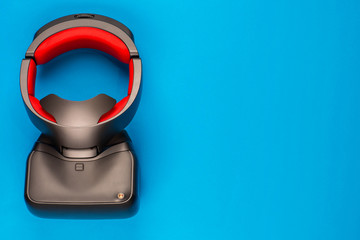 A vr set on blue background, shot from above, aligned to the left.