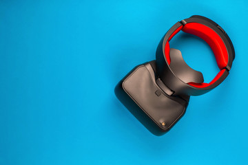 A vr set on blue background, shot from above, aligned at the top right.