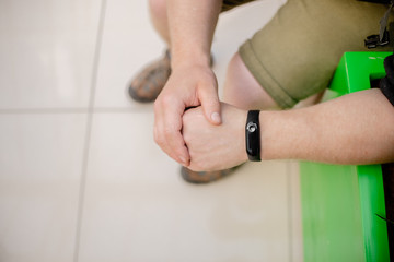 Man is wearing a fitness bracelet. Smart watch on the hand of a man. Pensioner Using Fitness Tracker.