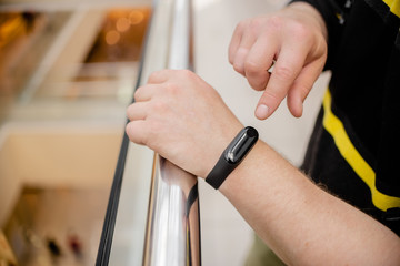 Man is wearing a fitness bracelet. Smart watch on the hand of a man. Pensioner Using Fitness Tracker.