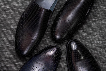 Close up black polished shoes on black background.Shoes shine.