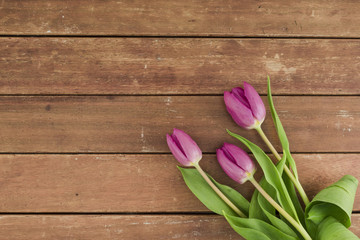 Top view flowers on wooden background with copy space