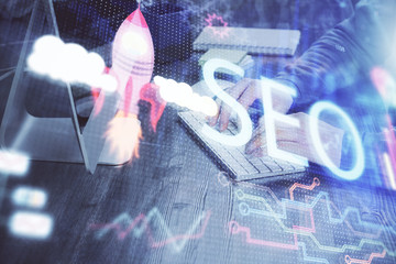 Double exposure of seo icon with man working on computer on background. Concept of search engine...