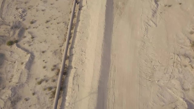 Long oil pipeline in the desert reveal aerial footage (4K)