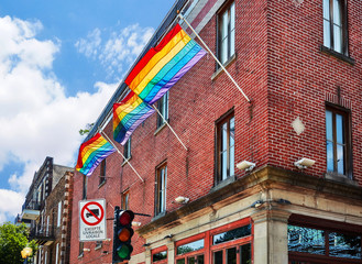 Rainbow gay pride flags waving on the flag pole