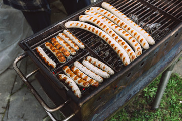 Barbequing sausages on hot grill. Top view.