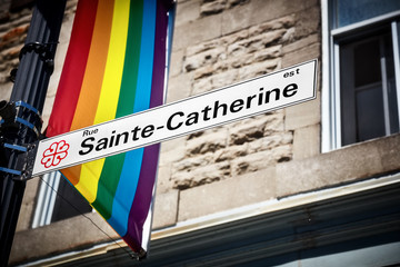 Sainte Catherine street sign and a LGBT rainbow gay pride flag