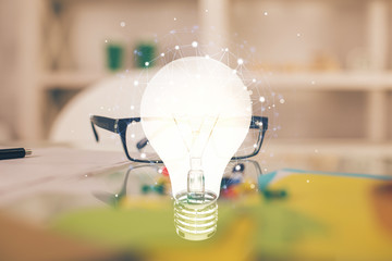 Bulb drawing with glasses on the table background. Idea concept. Double exposure.