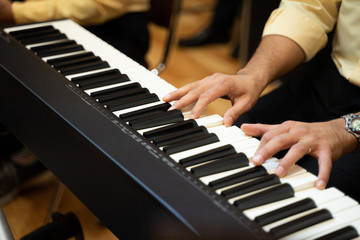 Fototapeta premium Men playing piano pianos in charity concert shows