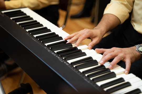 Men playing piano pianos in charity concert shows
