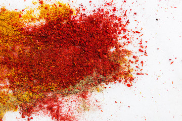Variety of different ground spices in powder peppers paprika turmeric spilled in explosion effect on white marble stone background. Food ingredients aromatic flavorful condiments oriental cuisine - obrazy, fototapety, plakaty