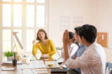 Fototapeta premium Young business group or business partners discussing documents and ideas at meeting