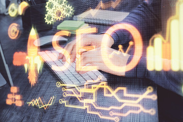 Multi exposure of seo icon with man working on computer on background. Concept of search engine...