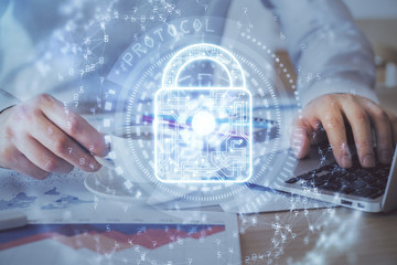 Multi exposure of lock icon with man working on computer on background. Concept of network protection.