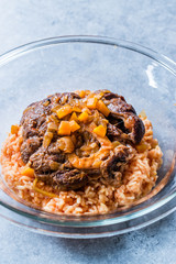 Osso Buco, Veal Shanks that are Braised in Wine with Saffron Risotto, Roasted Red Pepper and Rosemary.