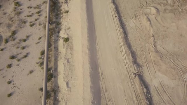 Long oil pipeline in the desert &ndash; side aerial footage (4K)