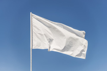 White flag against the blue sky - 274209223