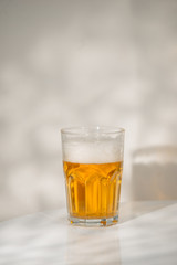 A glass of beer on the table.