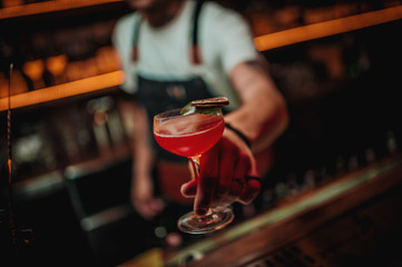 red coctail in hand barista