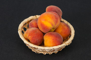 Peach heap in the wooden basket