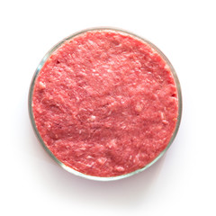 Laboratory studies of artificial meat. Minced meat in glass Petri dish. Square image. Close up. View from above. Chemical experiment.