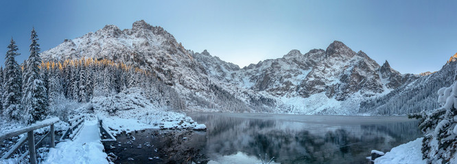 Winter mountains. Scenic frosty mountain landscape. Mountain icy lake. Winter panorama of Tatra mountains in Morskie Oko lake, Poland