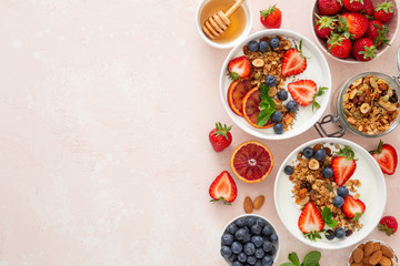Healthy breakfast concept. Food background with homemade granola, honey, yogurt and fresh berries.