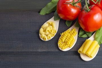 Uncooked pasta in a wooden spoon
