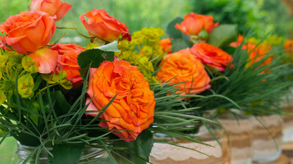 Beautiful orange roses in glass jars - close up