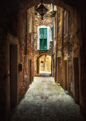 Fototapeta na wymiar Narrow pedestrian street and cozy countryard in the old town of Dolceacqua, Imperia province, Liguria region, Italy