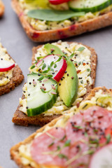 Sandwiches with cream cheese, vegetables and salami.