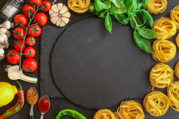 pasta, tagliatelle and sauce (set of ingredients, tomato, basil, garlic and more). top food background. copy space