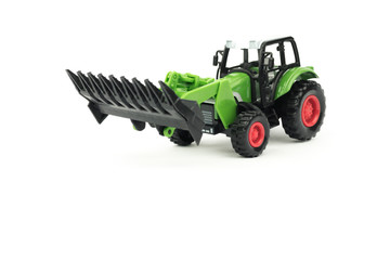 A small copy of the excavator. Toy tractor. Separate on a white background.